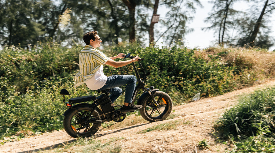 Man riding a Tesway s5 folding electric bike down a steep hill