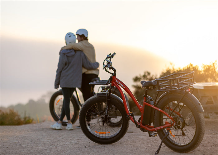 A couple rides a red wide tire Tesway s7 Ebike to the mountains to watch the sunrise