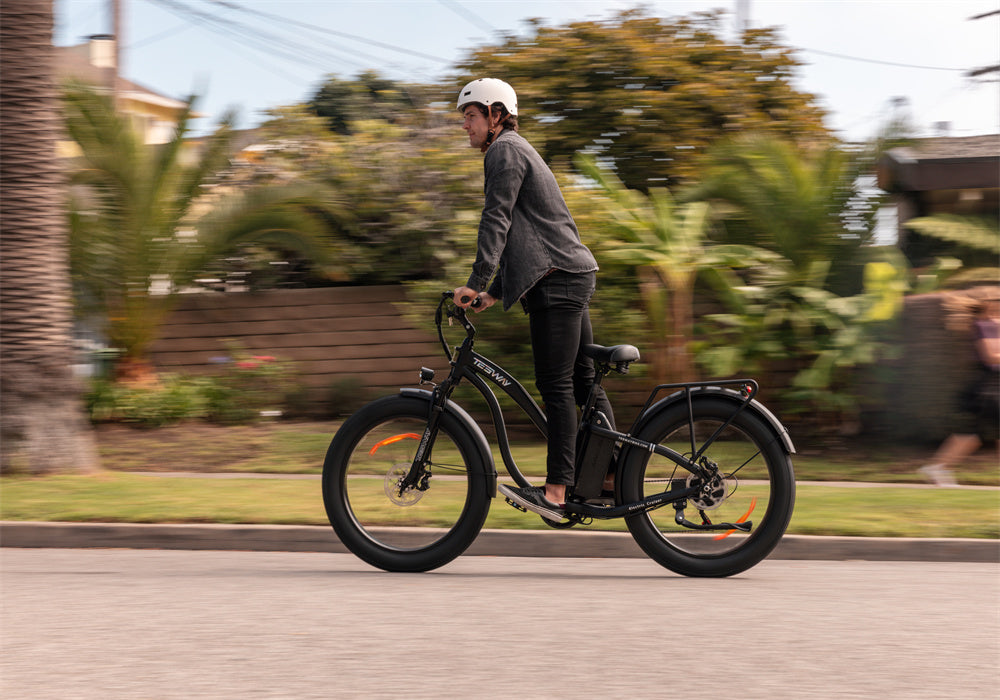 Riding black Tesway S7 fat tire ebike on the road