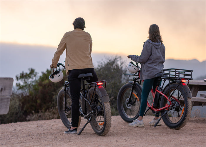Man riding a black Tesway s7 electric hybrid ebike and his wife riding a red Tesway S7